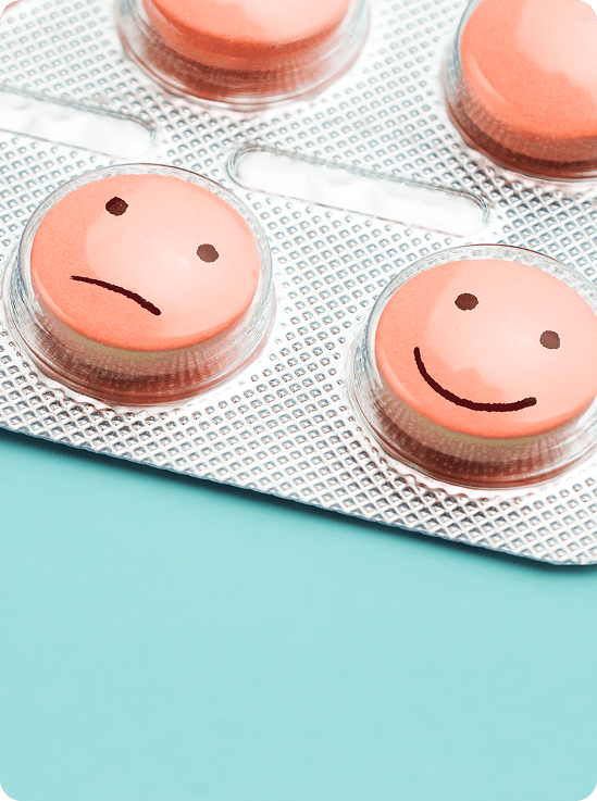 Tabletten met een blij en een verdrietig gezichtje